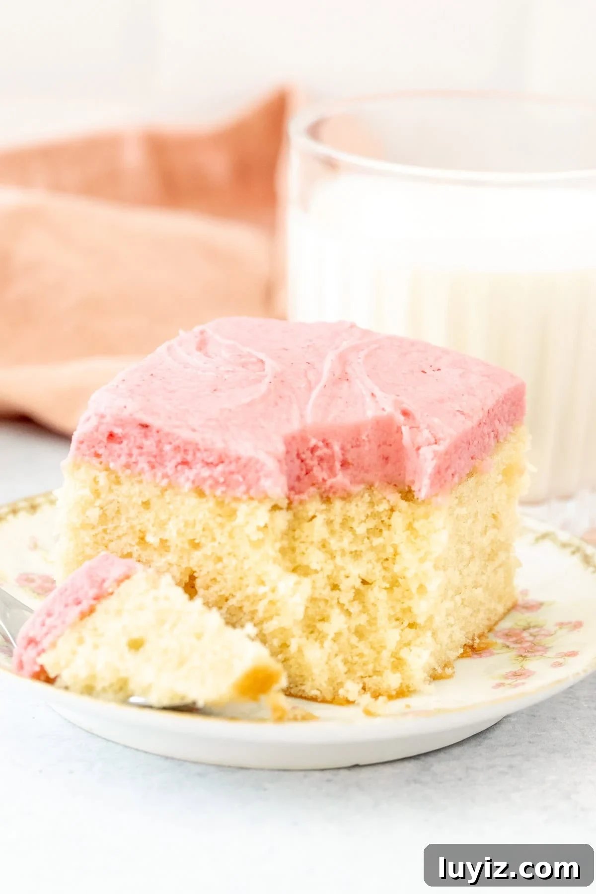 Vanilla Layer Cake with Strawberry Buttercream Frosting 5 Vanilla sheet cake with pink strawberry frosting with a bite taken out