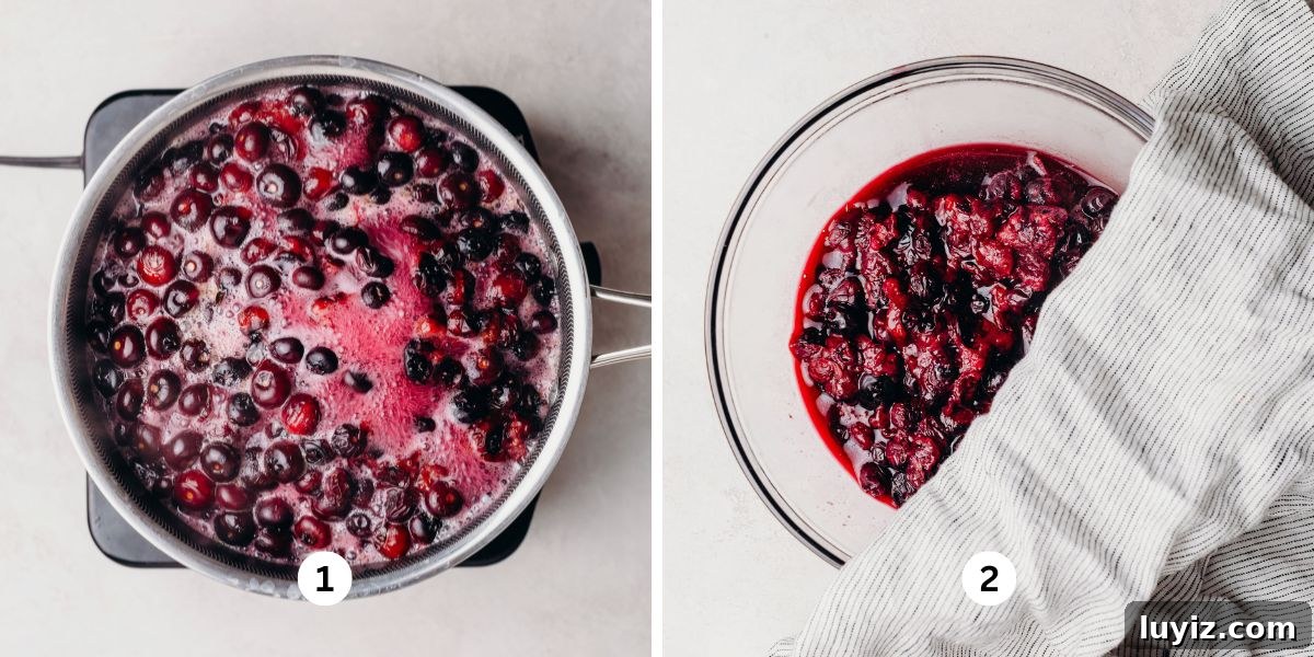 Blueberry Swirl Coffee Cake Recipe with Streusel Topping 5 Blanching blueberries in a large saucepan of boiling water on a burner then cooling the mixture in a glass bowl on a white background.