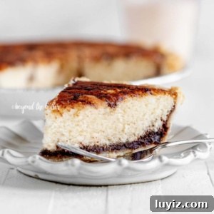 Pennsylvania Dutch Chocolate Funnust Cake Recipe 13 Slice of Pennsylvania dutch funny cake on dessert plate with fork with glass of milk and cake in background.