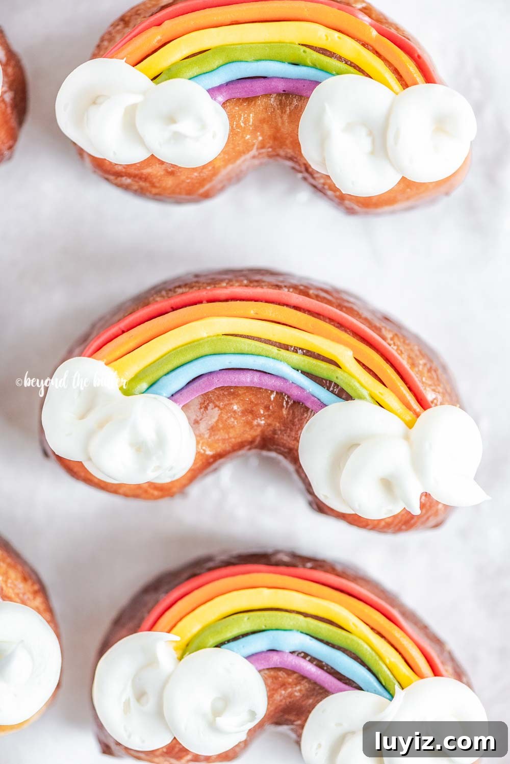 How to Make Vibrant Rainbow Donuts at Home 3 Overhead closeup image of homemade Rainbow Donuts | All Images © Beyond the Butter, LLC