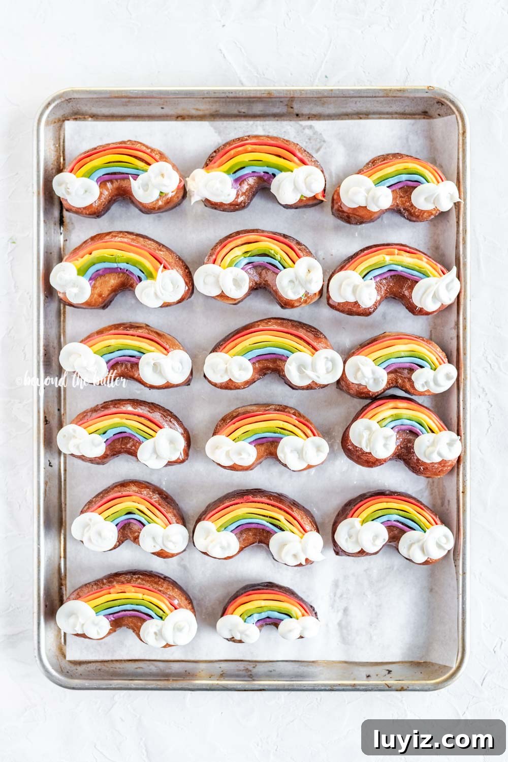 How to Make Vibrant Rainbow Donuts at Home 4 Overhead image of Rainbow Donuts on a baking sheet | All Images © Beyond the Butter, LLC