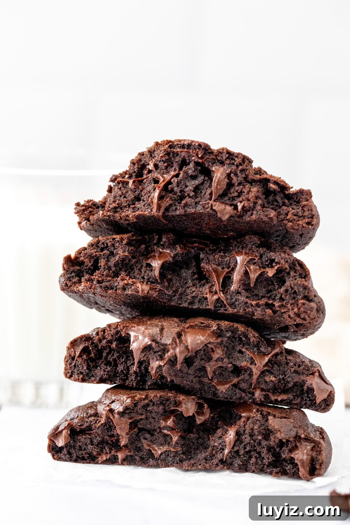 Bakery-Style Double Chocolate Chip Cookies Recipe 11 Stacked double chocolate cookies broken in half