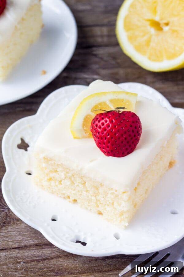 Lemon Cake with Cream Cheese Frosting Recipe & Tips 2 A slice of moist lemon cake topped with cream cheese frosting & berries on top.