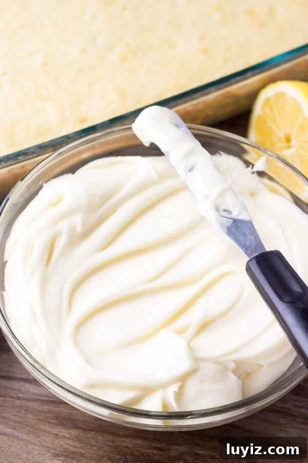 Lemon Cake with Cream Cheese Frosting Recipe & Tips 3 A bowl of fluffy lemon cream cheese frosting and a lemon sheet cake.