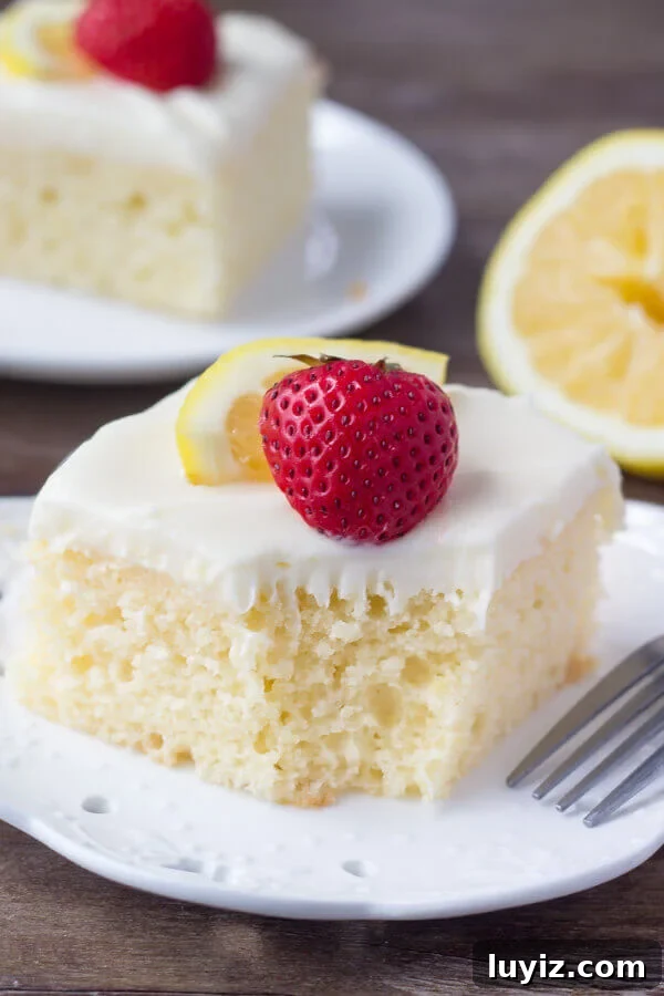 Lemon Cake with Cream Cheese Frosting Recipe & Tips 4 A slice of lemon cake with cream cheese icing with a bite taken out.