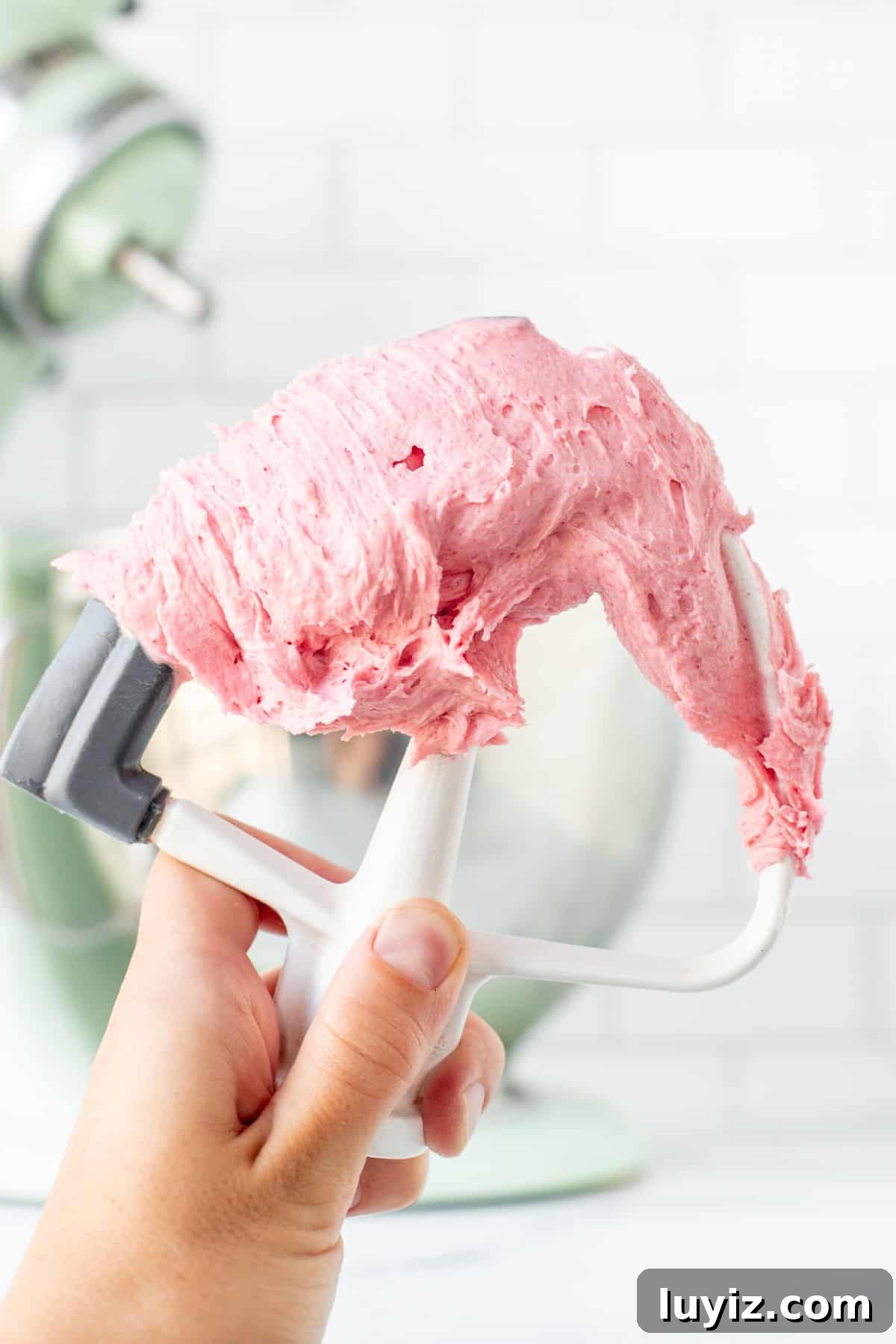 Raspberry Buttercream Frosting: Fresh vs Frozen Berries for Flavor 5 Kitchen beater with pink raspberry buttercream on it
