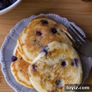 Blueberry Buttermilk Pancakes. Light, fluffy and bursting with blueberries - these pancakes are so much better than any mix!