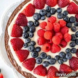 Decadent Brownie Fruit Pizza Recipe with Fresh Berries 8 9-inch round brownie topped with cream cheese frosting and fresh berries