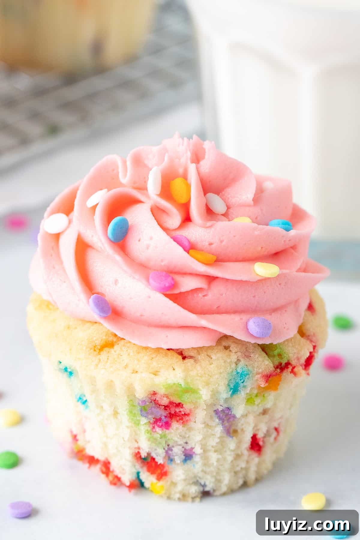 Funfetti Sprinkle Cupcakes: Classic Celebration Cupcake Recipe 2 Funfetti cupcake with pink frosting and glass of milk