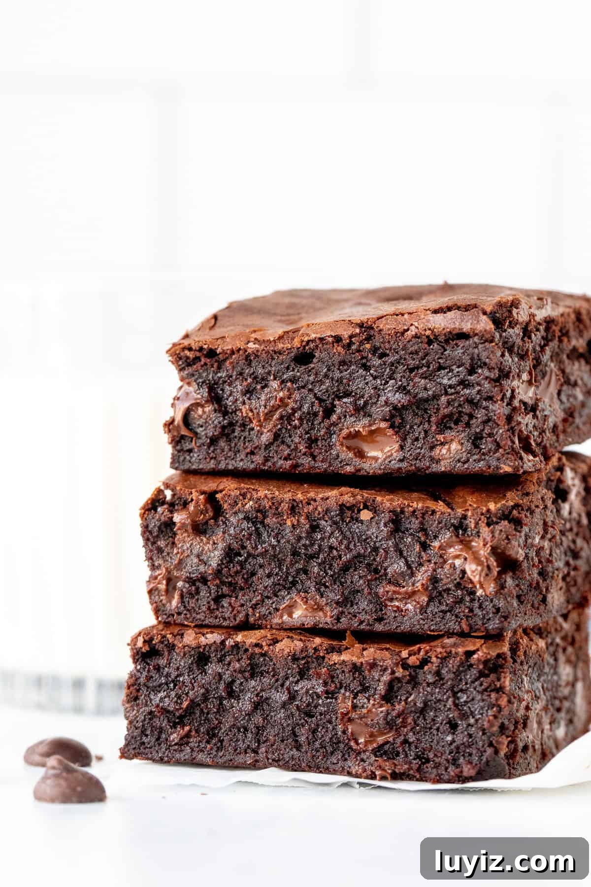One-Bowl Chewy Fudge Brownies Recipe 2 Stack of three chewy brownies with glass of milk