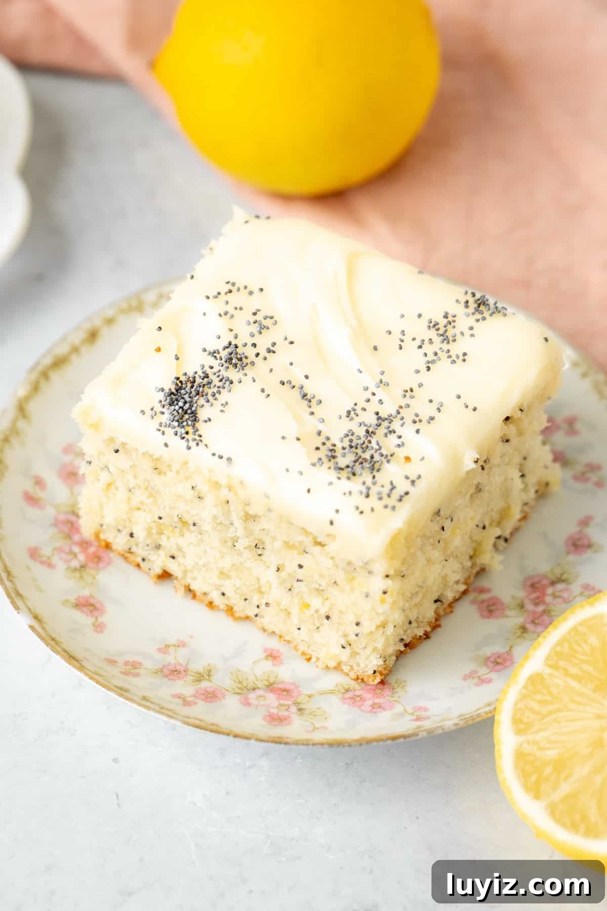 Lemon Poppy Seed Cake with Cream Cheese Frosting Recipe 3 Piece of lemon cake with poppy seeds iced with crema cheese icing and sprinkled with poppy seeds