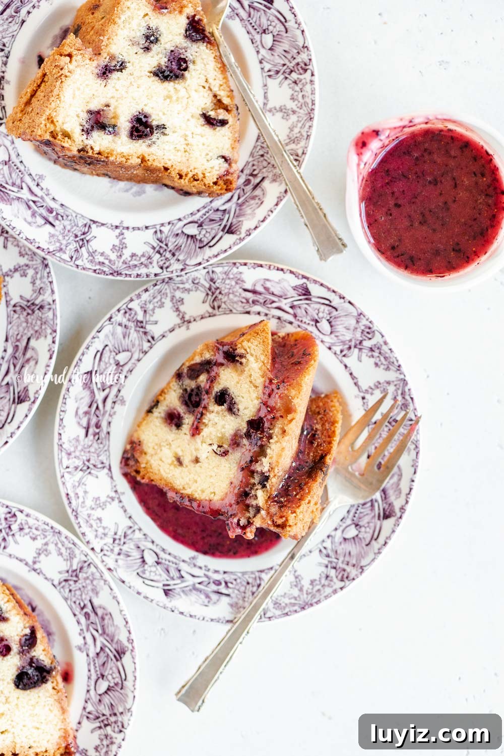 Moist Blueberry Bundt Cake with Lemon Glaze 3 Slices of blueberry bundt cake with blueberry glaze drizzled over the top | All Images © Beyond the Butter, LLC