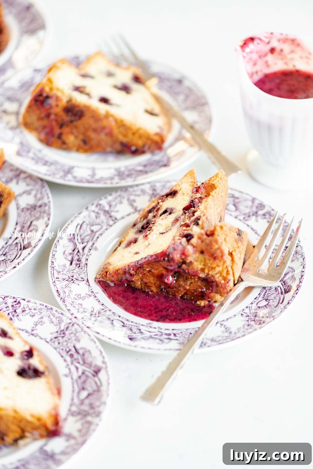 Moist Blueberry Bundt Cake with Lemon Glaze 5 Slices of blueberry bundt cake with blueberry glaze drizzled over the top | All Images © Beyond the Butter, LLC