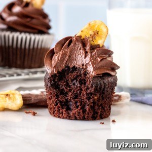 Double Chocolate Banana Cupcakes Recipe — Moist Chocolate Banana Treats 5 Chocolate cupcake with chocolate frosting with a bite taken out
