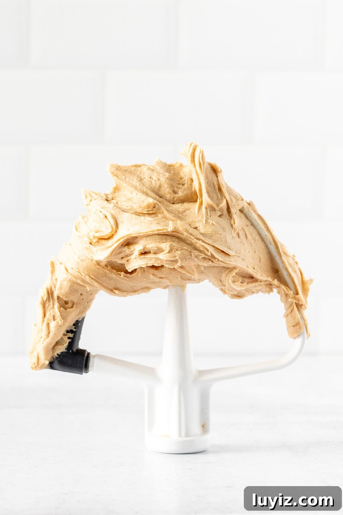 Creamy Peanut Butter Frosting Recipe for Cakes and Cupcakes 4 Paddle attachment of kitchen mixer with peanut butter frosting