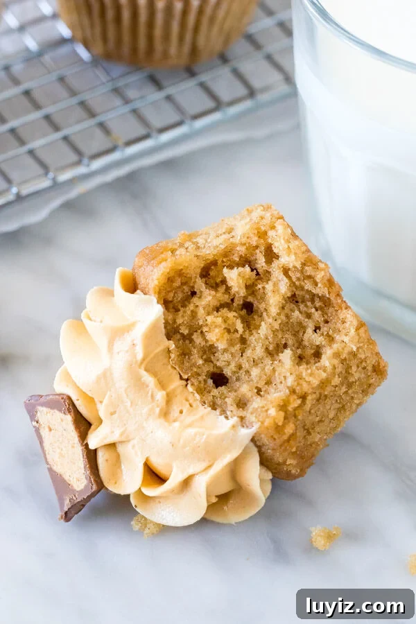 Decadent Peanut Butter Cupcake Recipe with Chocolate Swirl 4 Cupcake with a bite taken out of it, on its side.