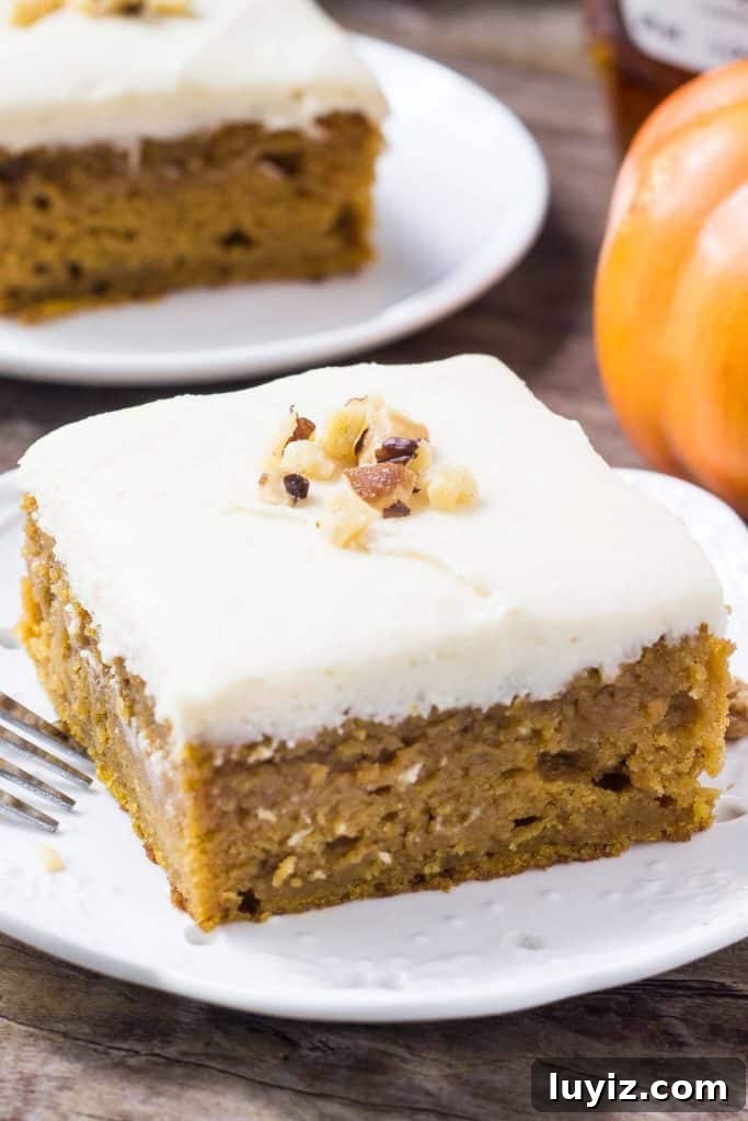 Pumpkin Cake with Maple Frosting Recipe for Fall Desserts 2 Pumpkin cake with maple frosting on a plate