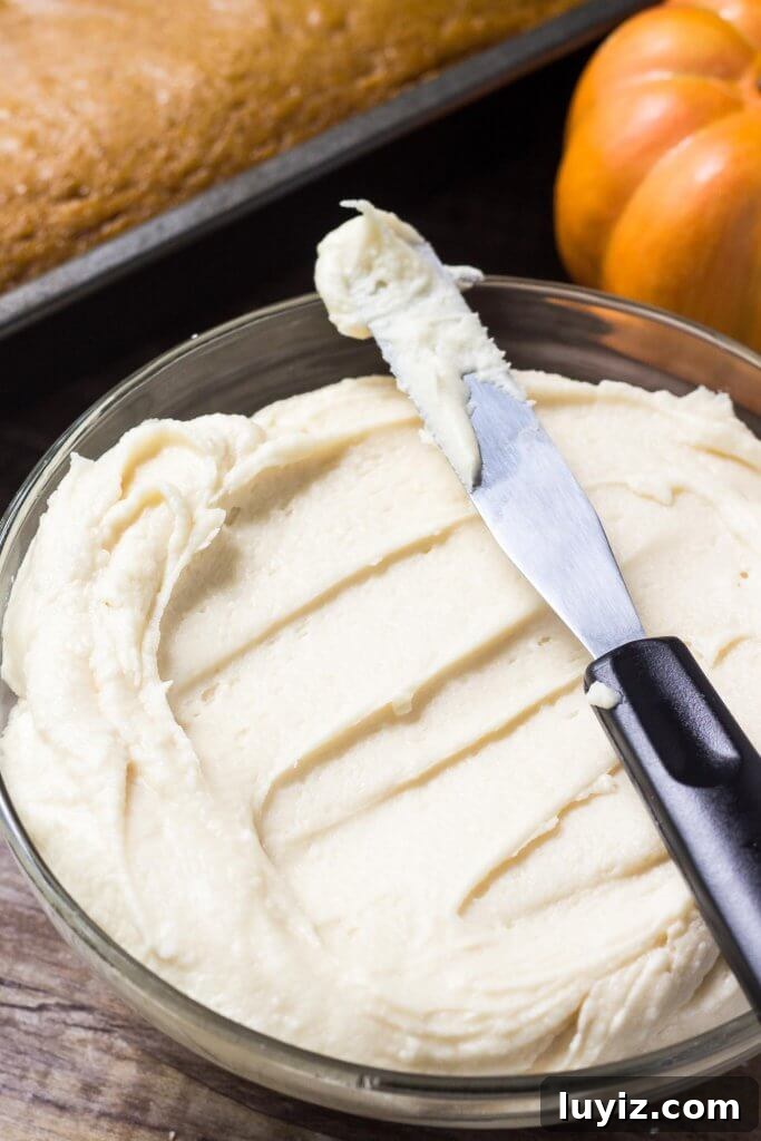 Pumpkin Cake with Maple Frosting Recipe for Fall Desserts 3 Slice of pumpkin cake topped with maple buttercream
