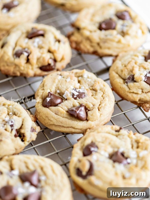 Funfetti Butter Cookies Recipe with Sprinkle-Filled Shortbread 10 Wire cooling rack of super soft chocolate chip cookies on white wood table.