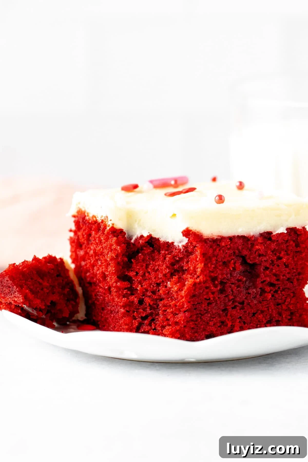 Classic Red Velvet Cake Recipe for Moist, Perfect Layers 12 Slice of easy red velvet cake with a bite taken out