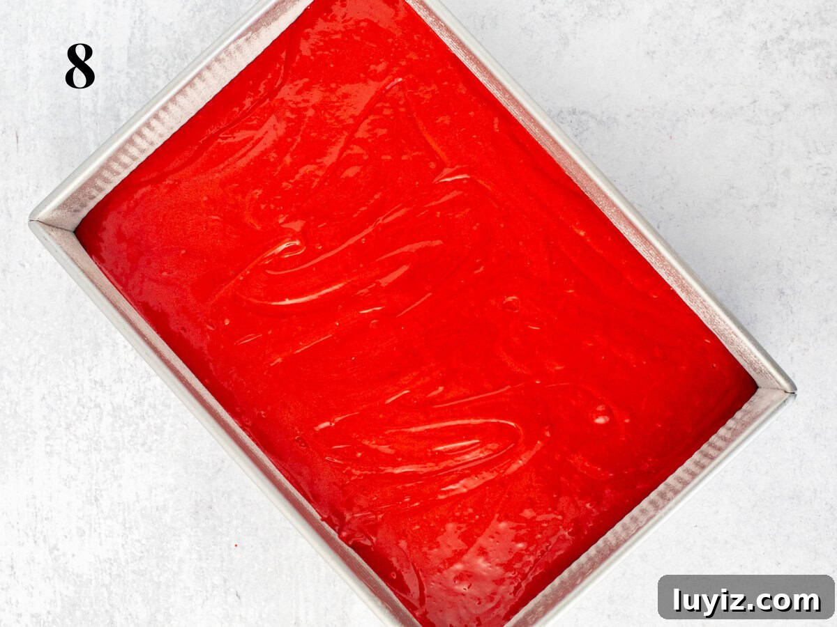Classic Red Velvet Cake Recipe for Moist, Perfect Layers 10 cake pan filled with red velvet cake batter