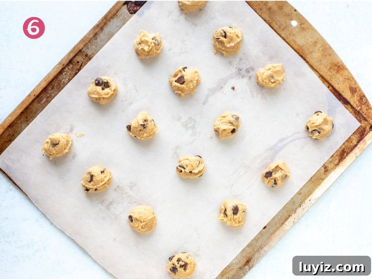 Mini Chocolate Chip Cookie Recipe: Bite-Sized Cookies for Snacking 6 Lined cookie sheet with unbaked mini cookie dough balls