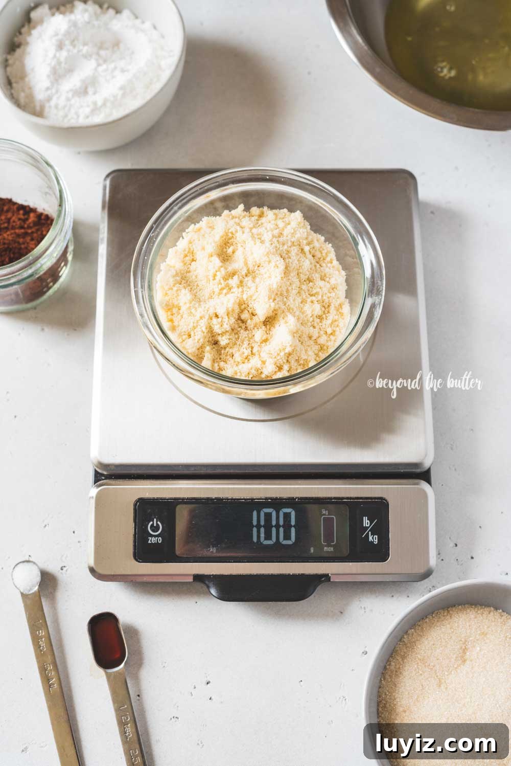Decadent Dark Chocolate Macarons Recipe for Perfect Crisps 10 Angled image of dark chocolate macaron ingredients being weighed | All Images © Beyond the Butter™