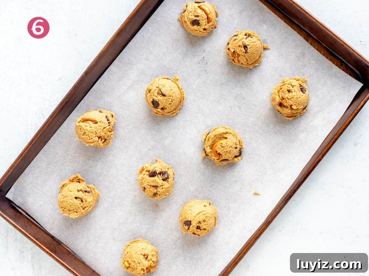 Peanut Butter Pretzel Chocolate Chip Cookies Recipe 6 Lined cookie sheet of peanut butter pretzel cookie dough balls