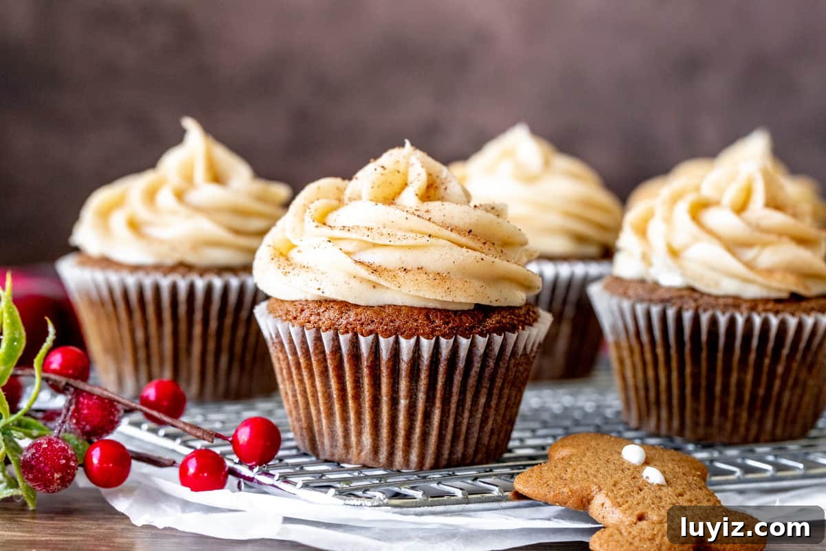 Gingerbread Cupcakes with Silky Cream Cheese Frosting 5 Gingerbread cupcakes topped with cinnamon cream cheese frosting on cooling rack