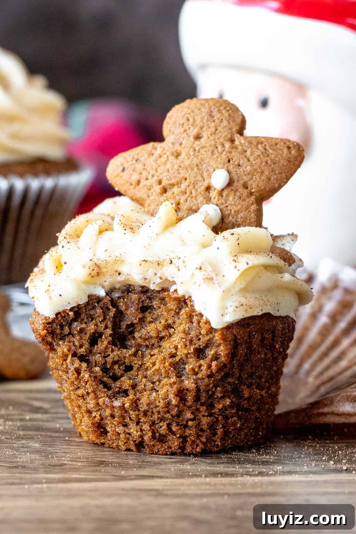 Gingerbread Cupcakes with Silky Cream Cheese Frosting 8 Frosted cupcake with a bite taken out