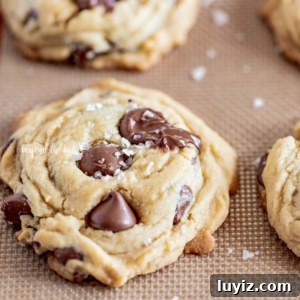 Ultimate Melt-in-Your-Mouth Chocolate Chip Cookies 13 Soft chocolate chip cookies on a silicone baking sheet.