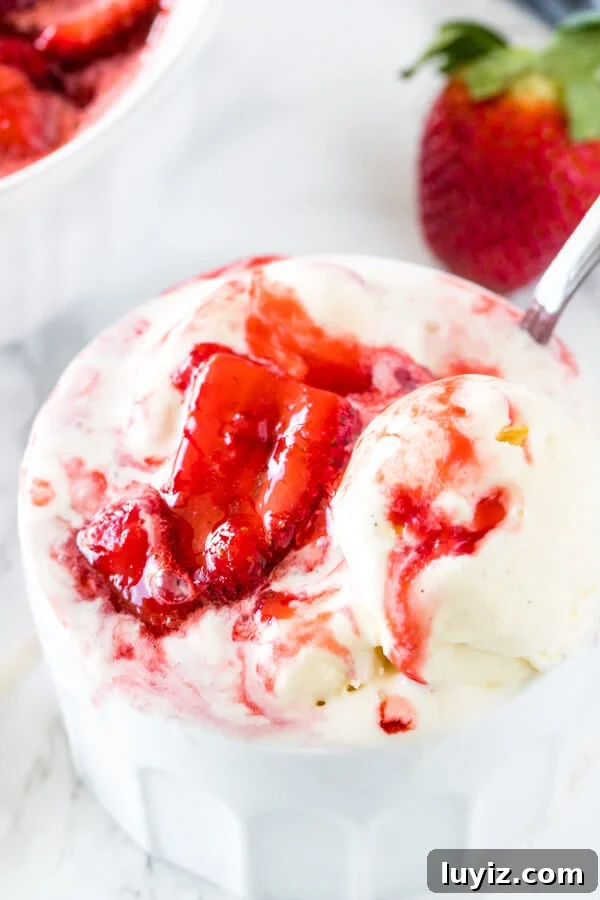 Homemade Strawberry Sauce Recipe for Desserts and Toppings 4 A bowl of ice cream with strawberry sundae sauce with thick, juicy pieces of berries and the ice cream starting to melt.
