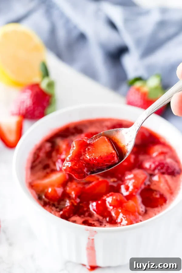 Homemade Strawberry Sauce Recipe for Desserts and Toppings 5 A dish filled with strawberry sauce to serve on cheesecake, pancakes or ice cream. A spoon serving the sauce to show the juicy strawberry pieces.
