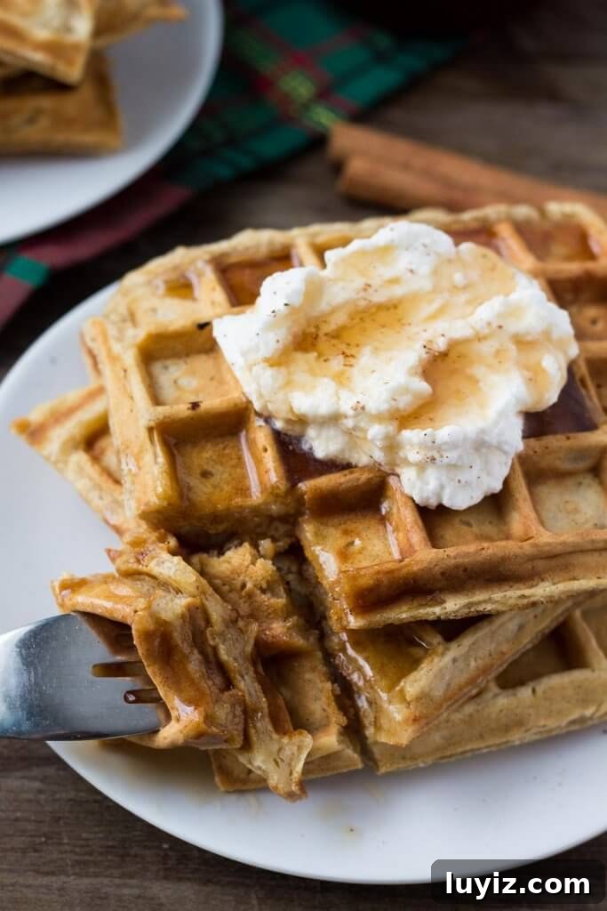 Fluffy Eggnog Waffles Recipe for Holiday Brunch 4 Stack of eggnog waffles ready for maple syrup