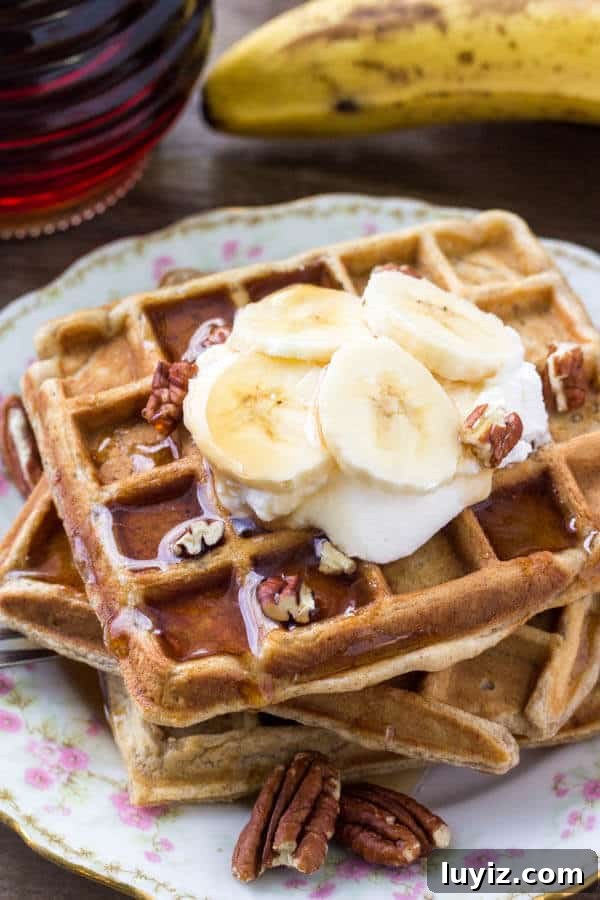 Cinnamon-Stuffed Banana Bread Waffles — Light & Fluffy 2 A stack of fluffy banana waffles taste like banana bread topped with maple syrup, whipped cream & sliced bananas.