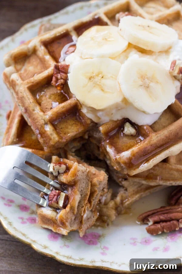 Cinnamon-Stuffed Banana Bread Waffles — Light & Fluffy 5 A bite of fluffy banana waffles.