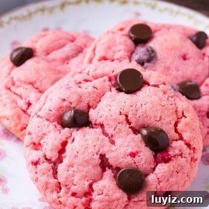 Strawberry cookies are soft and gooey. They're made with cake mix so they're super easy and filled with chocolate chips.