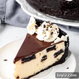 Decadent Oreo Cheesecake Recipe: Creamy Cookies & Cream Dessert 8 Slice of Oreo Cheesecake with chocolate ganache and whipped cream rosettes on top