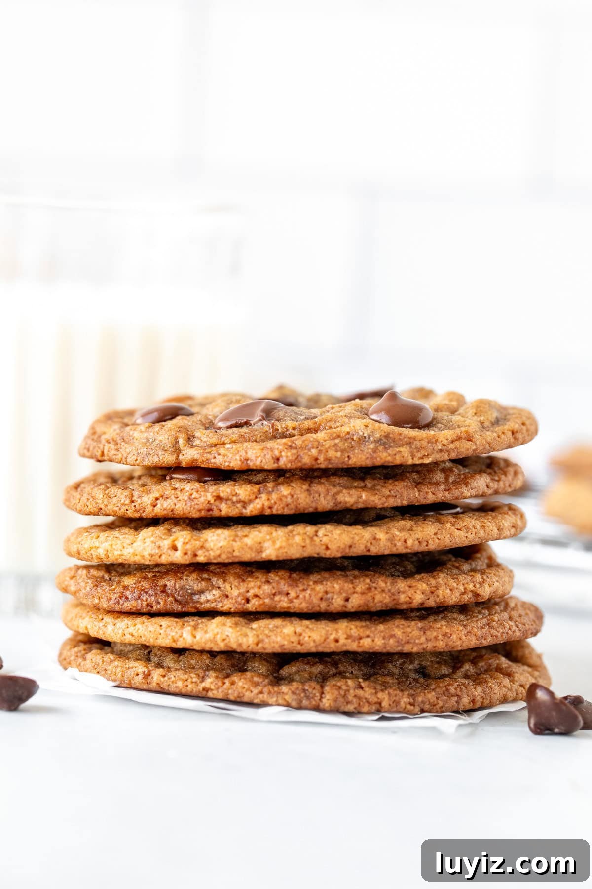 Chewy Banana Chocolate Chip Cookie Recipe You’ll Love 3 Stack of banana bread cookies with a glass of milk