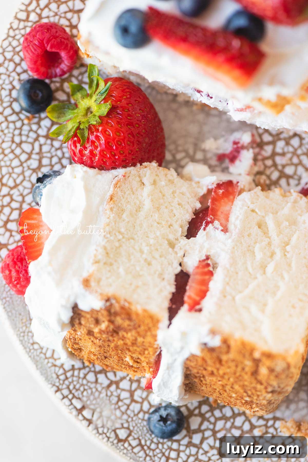 Light and Fluffy Homemade Angel Food Cake Recipe 6 Close up image of angel food cake with berries