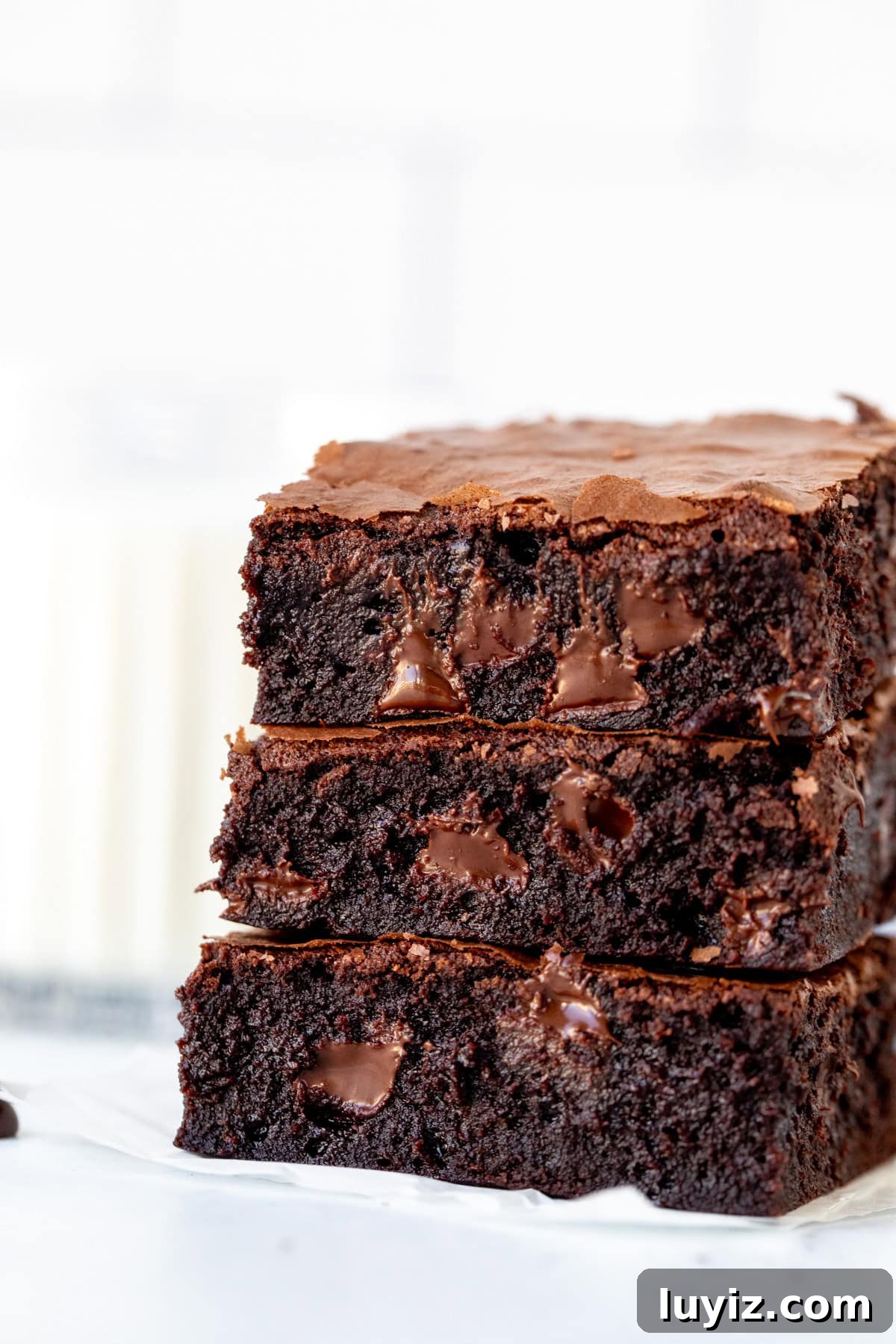 Ultimate Triple Chocolate Brownies Recipe: Decadent Fudgy Squares 2 Stack of three triple chocolate brownies with glass of milk