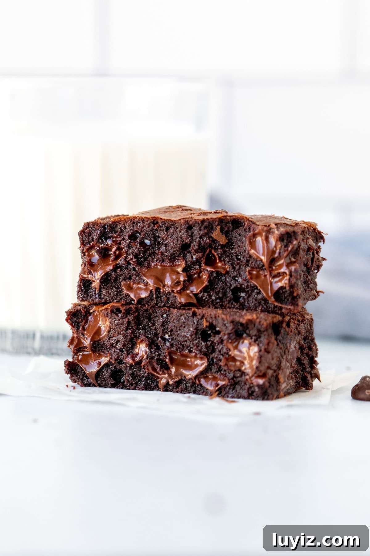 Ultimate Triple Chocolate Brownies Recipe: Decadent Fudgy Squares 4 Triple chocolate fudge brownie, broken in half with melted chocolate chips