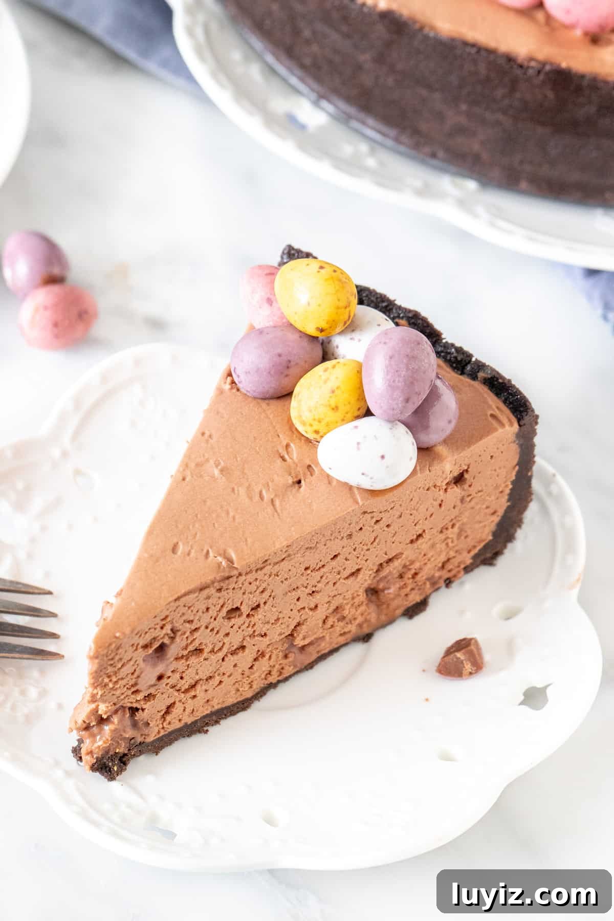Mini Egg Chocolate Cheesecake Cups (No-Bake) 2 Slice of chocolate cheesecake with mini eggs on top