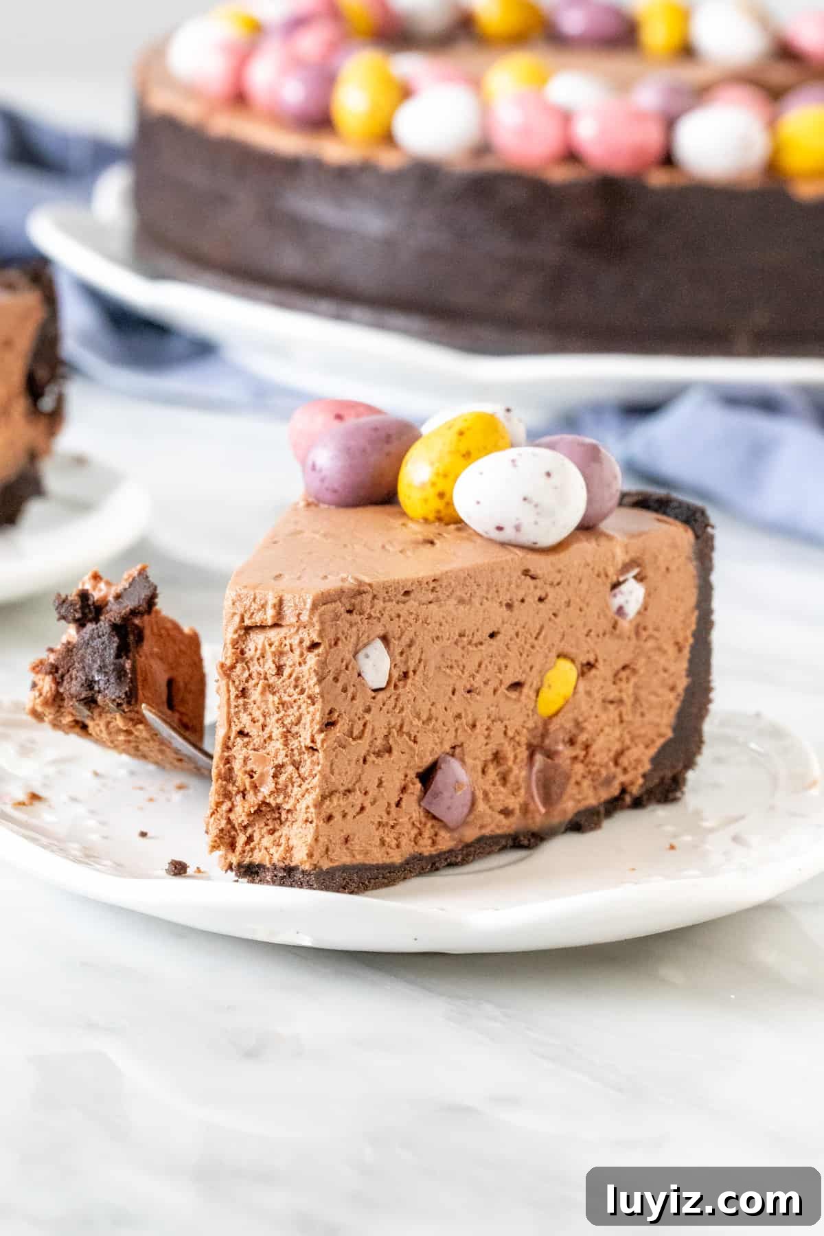 Mini Egg Chocolate Cheesecake Cups (No-Bake) 5 Slice of mini-egg cheesecake with a bite taken out of it.