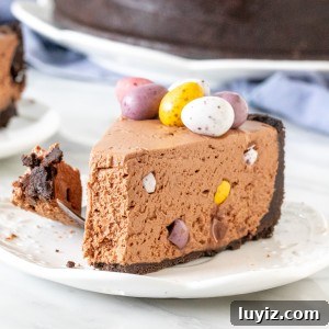 Slice of mini-egg cheesecake with a bite taken out of it.
