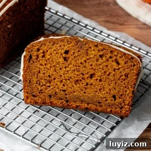 Moist Pumpkin Bread with Cream Cheese Glaze Recipe 7 Slice of pumpkin bread on cooling rack