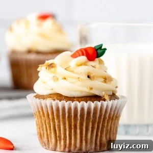 Moist Carrot Cupcakes with Cream Cheese Frosting 7 Carrot cake cupcake with cream cheese frosting and a glass of milk