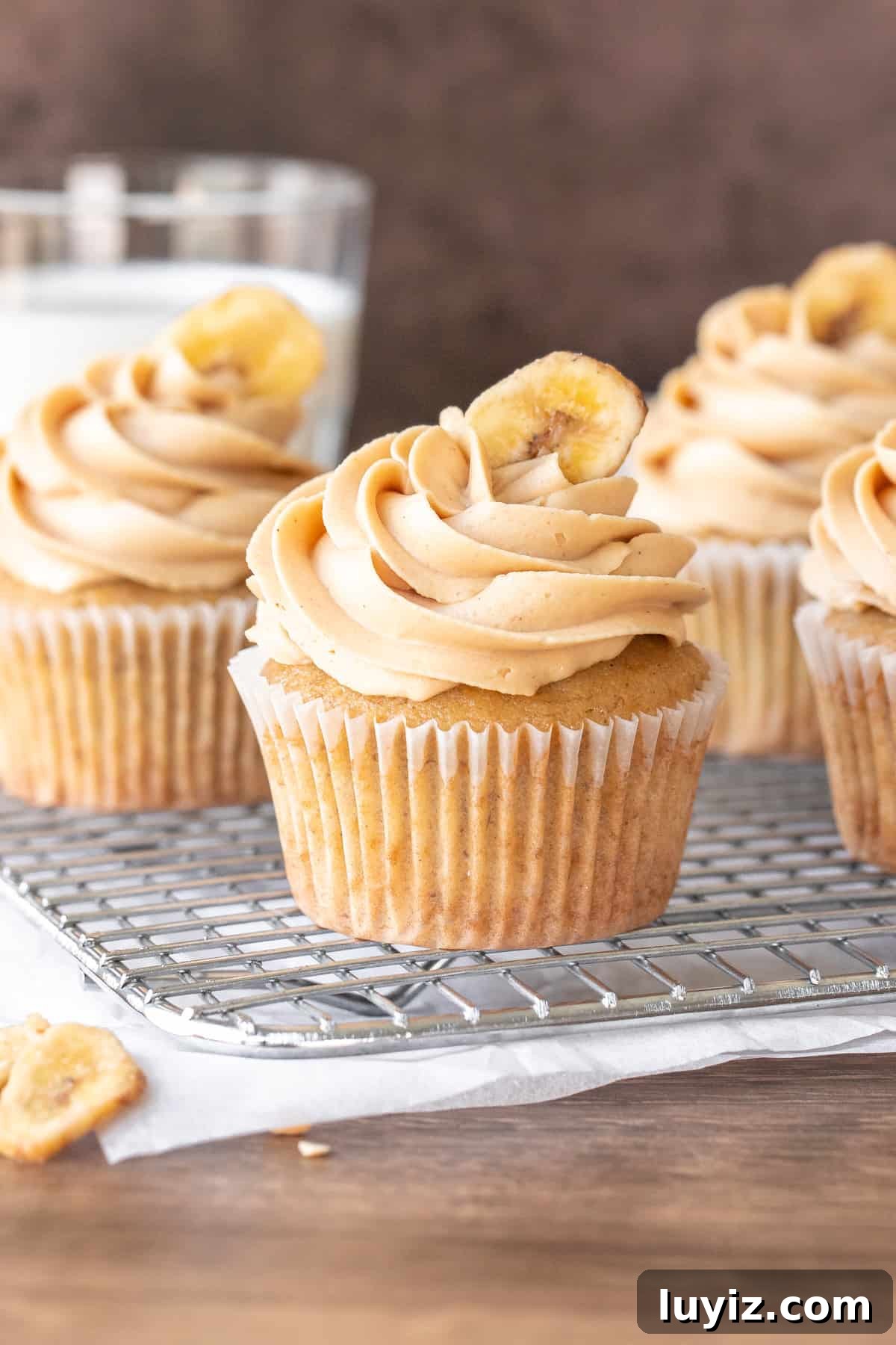 Peanut Butter Banana Cupcakes with Cream Cheese Frosting 2 Banana peanut butter cupcakes on a cooling rack