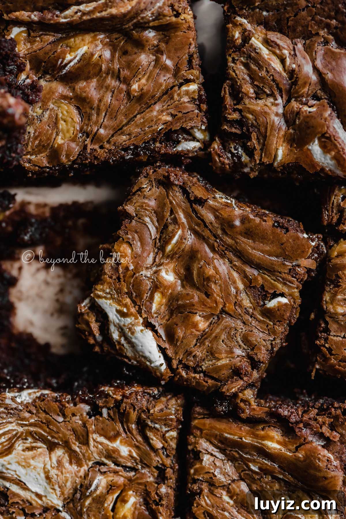 Marshmallow Peanut Butter Brownies Recipe — Gooey Chocolate Bars 8 Closeup of randomly placed marshmallow peanut butter brownies on parchment paper | All Images © Beyond the Butter™