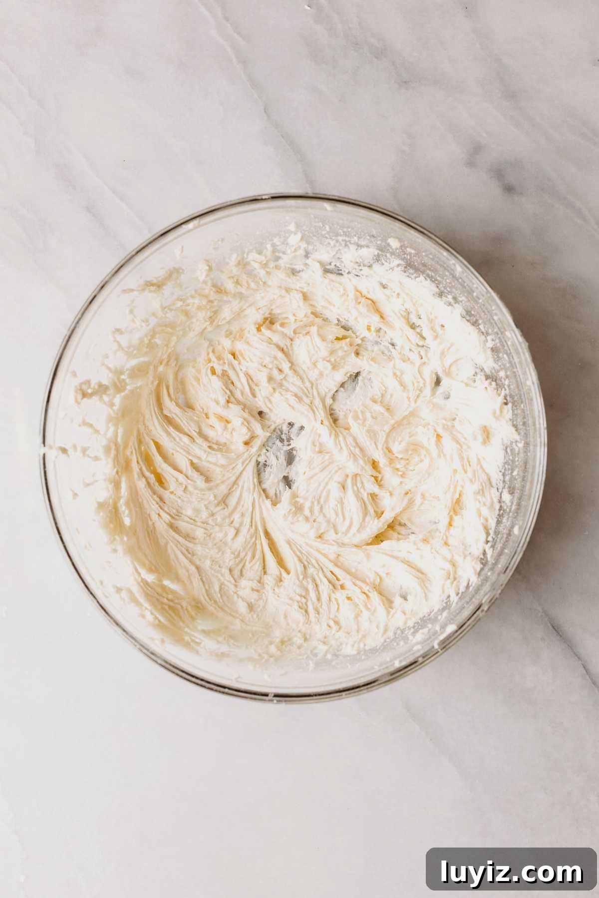 Pumpkin Whoopie Pies Recipe: Soft Spiced Sandwich Cookies 15 Maple cream cheese frosting in a large glass mixing bowl on a light grey marbled background.